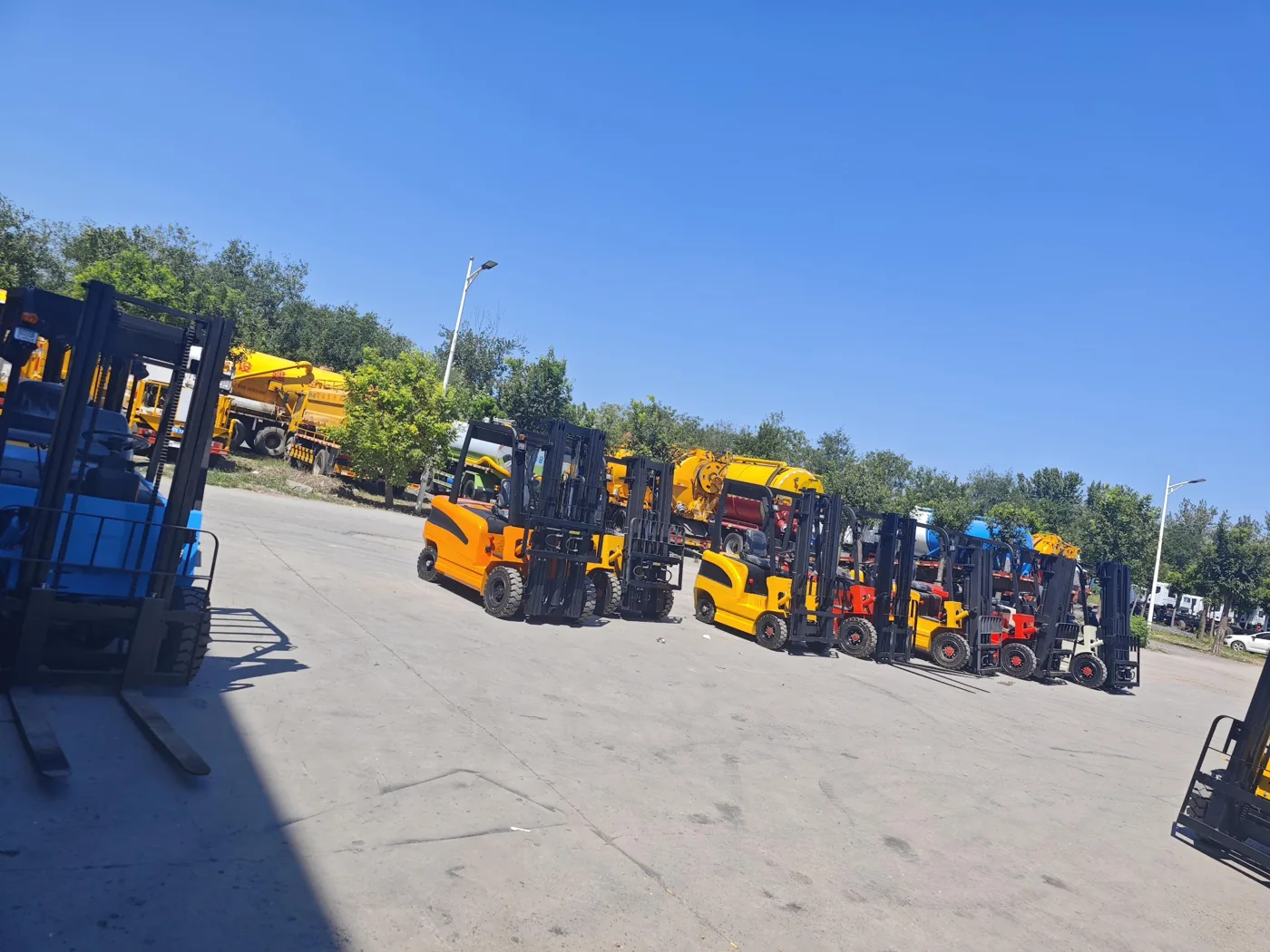Forklifts parked in an outdoor equipment yard in supplied reference photography